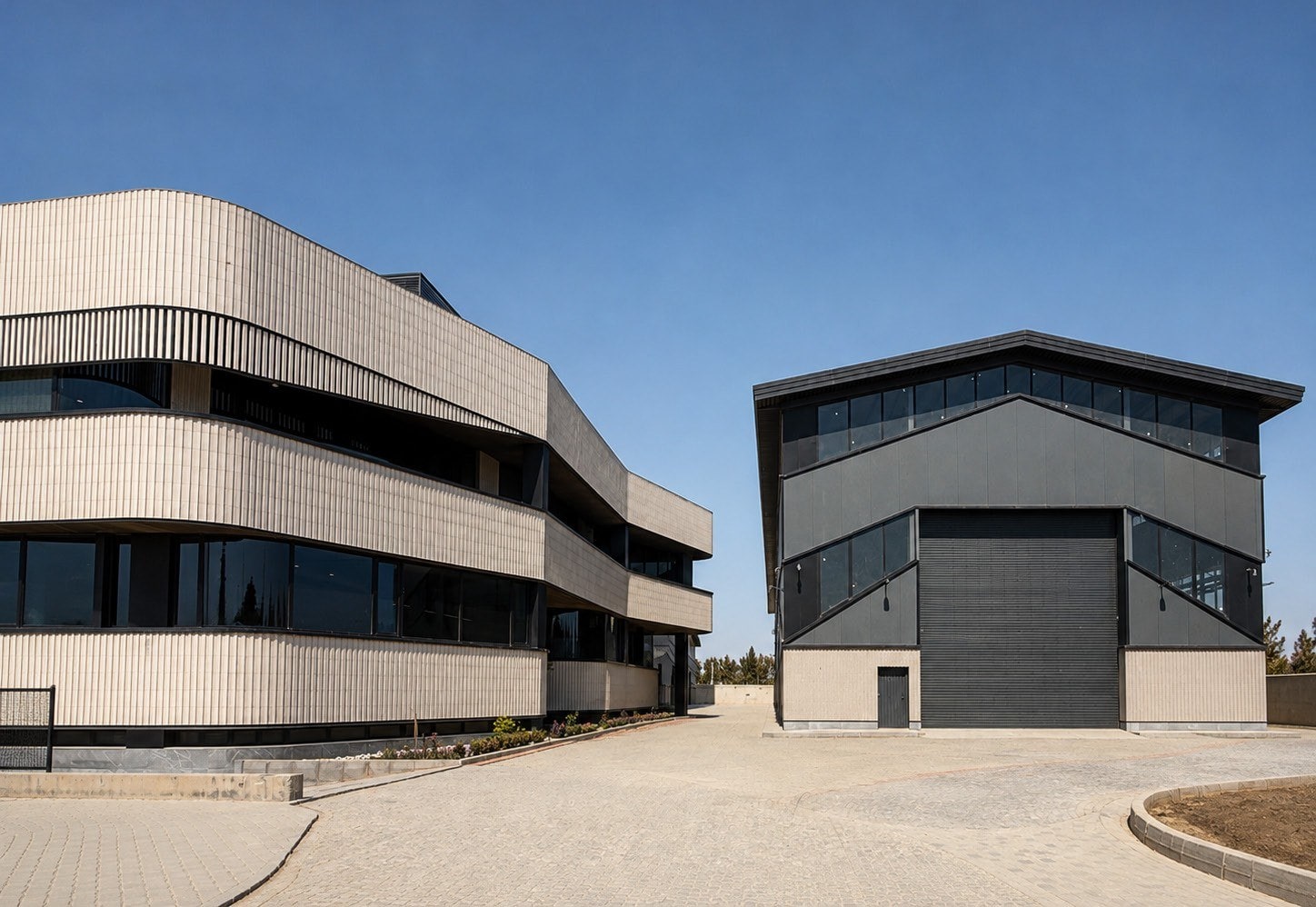 Office building beside the dark production hall