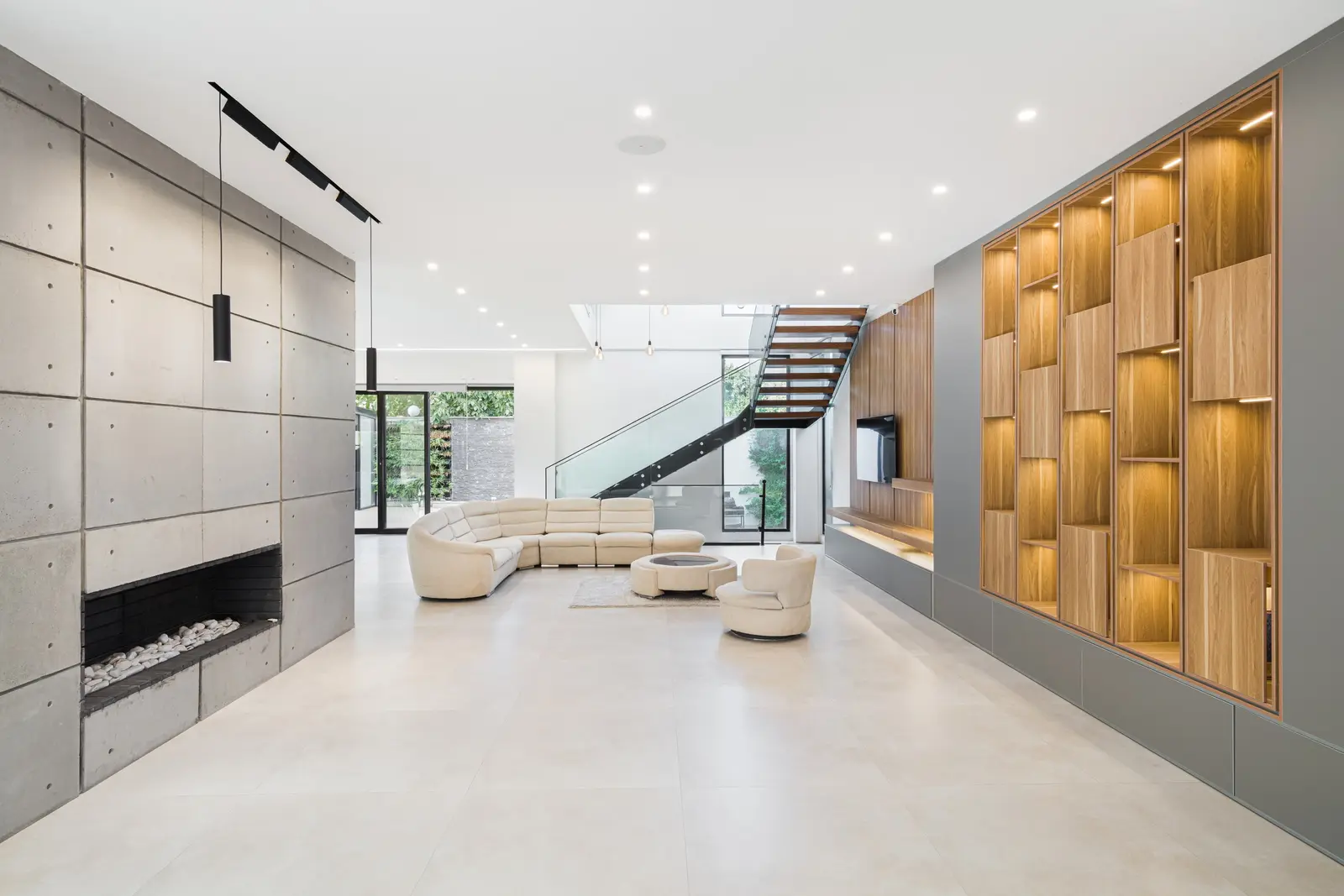 The long living space with the fireplace wall