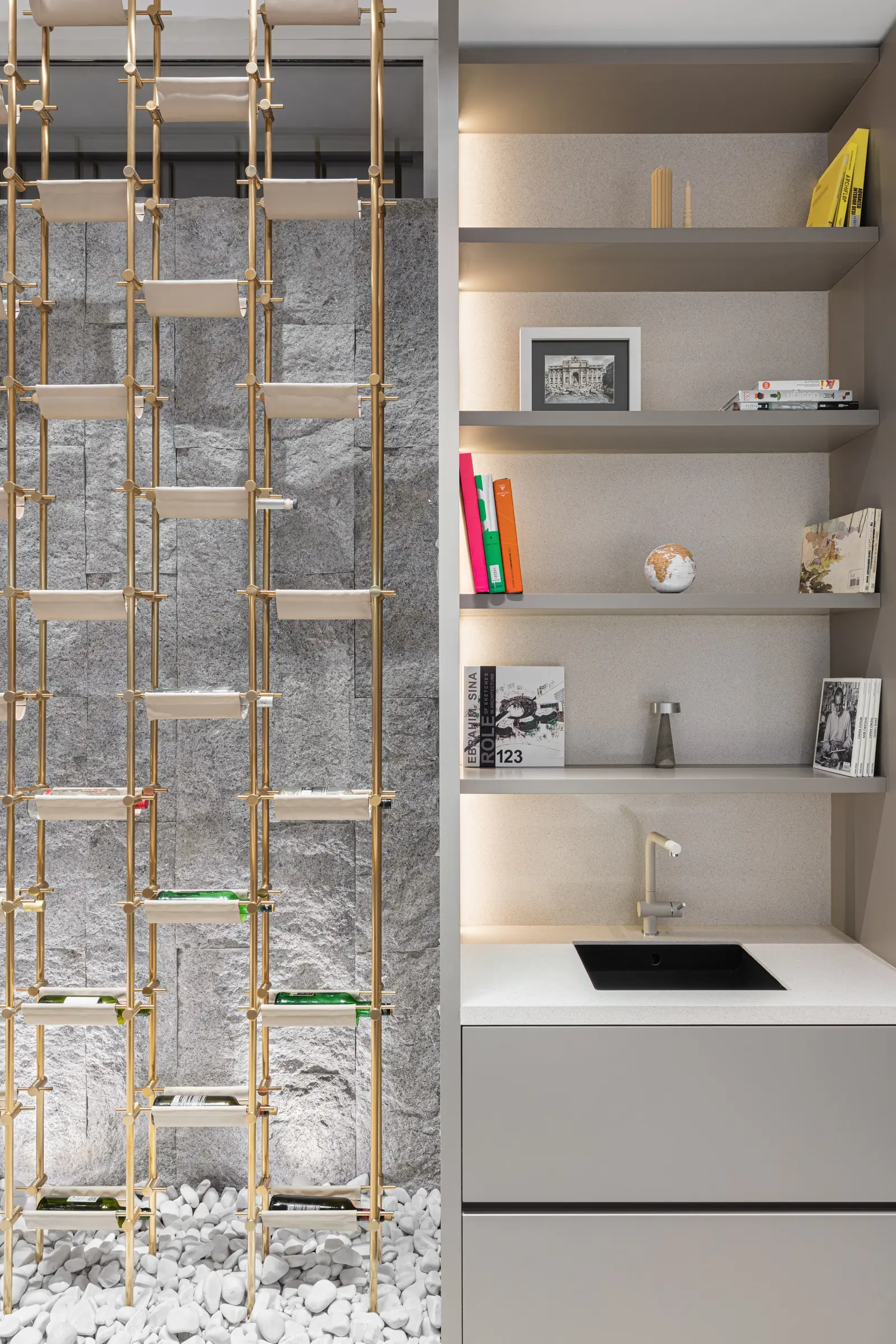 Brass ladder shelving against the stone wall